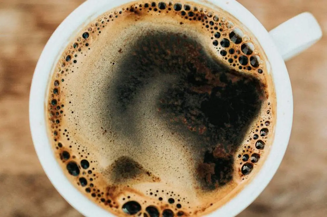 A cup of coffee with latte art on a saucer